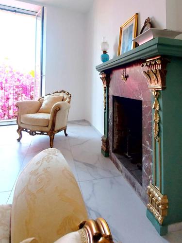 a living room with a couch and a fireplace at Villa Anna al Duomo in Taormina