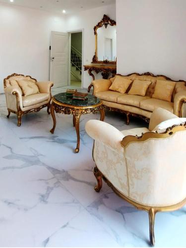 a living room with a couch and a table and chairs at Villa Anna al Duomo in Taormina