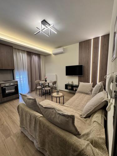 a living room with a bed and a dining room at JK Luxury Apartments in Nea Chili