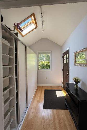 a room with a closet and a skylight at Beautiful two-bedroom residence nestled in the lovely town near Boston in Sharon
