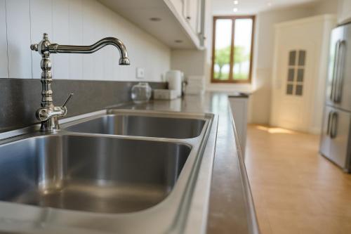 a kitchen sink with a faucet in a kitchen at Villa La Gioconda in Arezzo