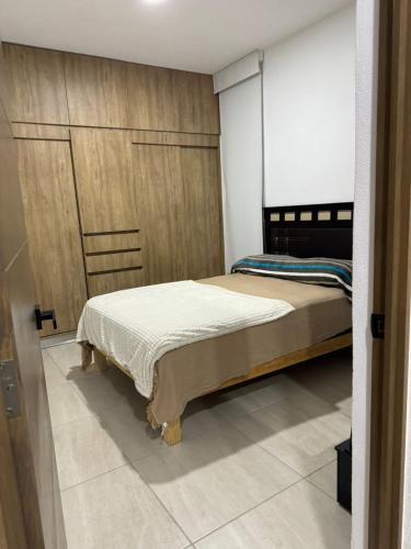 a bedroom with two beds and a sliding door at Departamento con Rooftop en Mezcales in Mezcales
