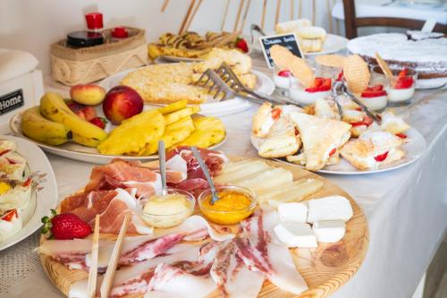 a table with many different types of food on it at B&B Steddueoro in Baunei