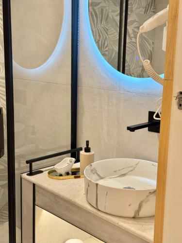 a bathroom with a sink and a mirror at Old Town Suites Muradie in Vlorë