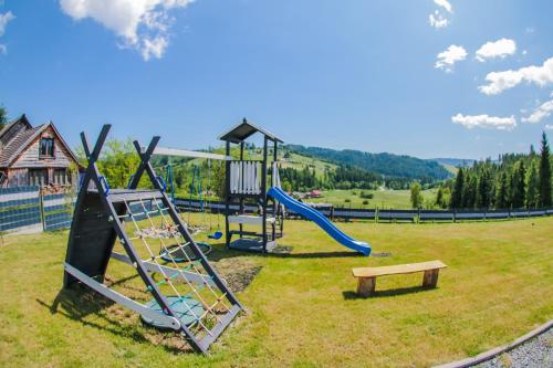 a park with a playground with a slide and a bench at Willa Jaworzynka 1103 K Istebnej in Jaworzynka