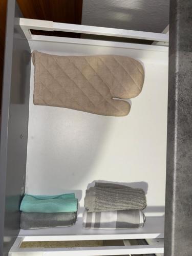 an open refrigerator with towels in the door at 70qm Apartment mit Stellplatz und Garten in Riegelsberg