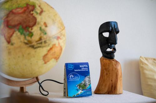 a figurine of a person wearing a gas mask next to a globe at B&B Steddueoro in Baunei