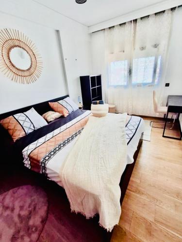 a bedroom with two beds and a mirror on the wall at Appartement a hivernage in Marrakech