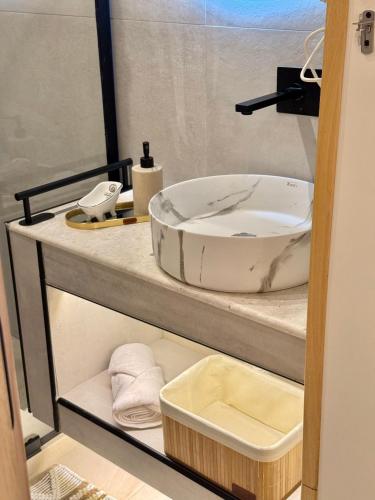 a bathroom with a sink on a counter at Old Town Suites Muradie in Vlorë