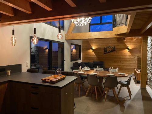 une cuisine et une salle à manger avec une table et des chaises dans l'établissement Le Palier, à Chorges