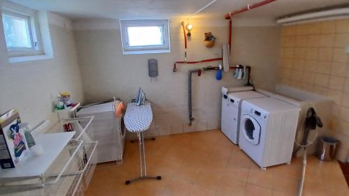 a laundry room with a washer and a washing machine at Ella's House - Central Bengtsfors Stay in Bengtsfors
