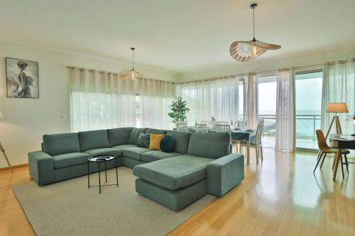 a living room with a blue couch and a table at The Panoramic View Suites in Machico