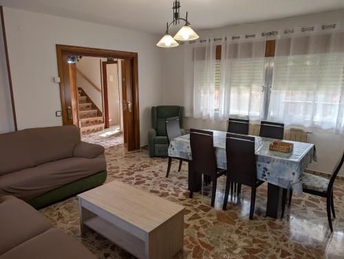 a living room with a couch and a table and chairs at la erilla vieja in Navarrevisca