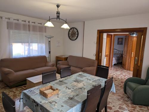 a living room with a table and a couch at la erilla vieja in Navarrevisca