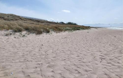 a sandy beach with footprints in the sand at Amazing Home In Karlino in Karlino