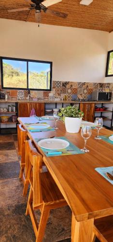a large wooden table with chairs and a tableablish at Blue Sky Lodge in Nicoya