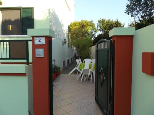 a gate to a patio with a table and chairs at Domus Girasoli in Alezio