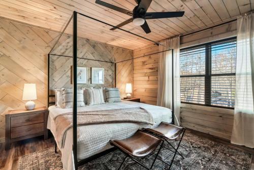a bedroom with a bed and a ceiling fan at Charming Hideaway with Private Pool Hot Tub & Views in Gatlinburg