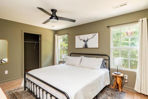 a bedroom with a bed and a ceiling fan at Comfortable Escape near Dolly w Hot Tub in Sevierville