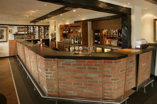 a brick bar in a room with a brick wall at Stirrups Hotel in Bracknell