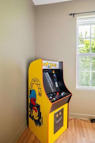a video game machine in a corner of a room at Comfortable Escape near Dolly w Hot Tub in Sevierville