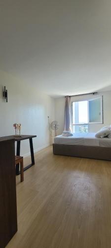 une chambre avec un lit, une table et une fenêtre dans l'établissement Charming Studio near La Defense, à Courbevoie