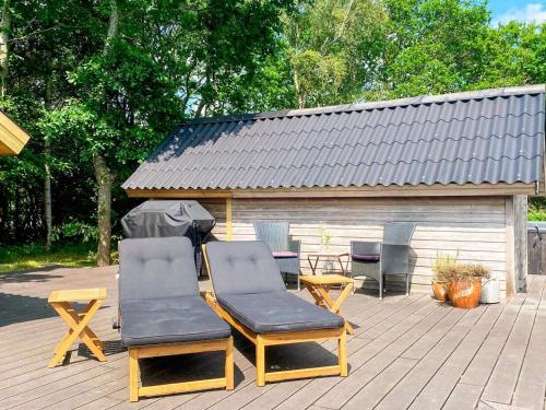 two chairs and a table on a patio at 4 person holiday home in Thisted-By Traum in Thisted