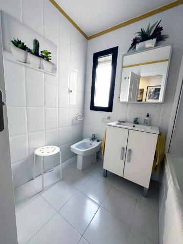 a white bathroom with a sink and a toilet at Paraíso del Sol in Salobreña