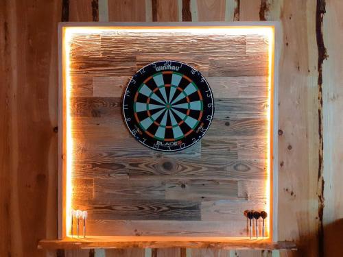a dart board on a wall with a light illuminating it at 5 star holiday home in Højslev in Højslev
