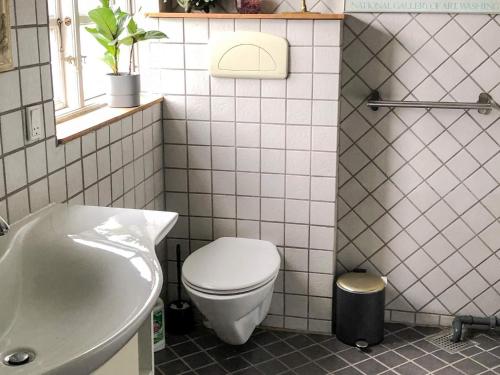 a bathroom with a toilet and a sink and a tub at 8 person holiday home in Gilleleje-By Traum in Gilleleje