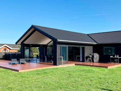 a house with a deck and a patio at Luxury Retreat in Marielyst - By Traum Ferienwohnungen in Bøtø By