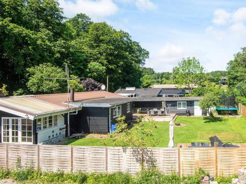 a house with a fence in front of it at 6 person holiday home in Haderslev in Haderslev