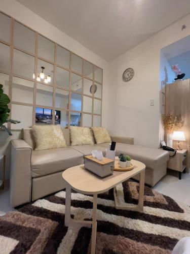 a living room with a couch and a table at Davao Inspiria Condominium units with balcony beside Abreeza Mall in Davao City
