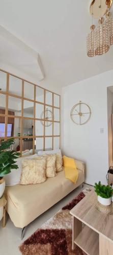 a living room with a couch and a table at Davao Inspiria Condominium units with balcony beside Abreeza Mall in Davao City