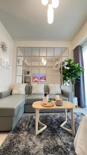 a living room with a couch and a coffee table at Davao Inspiria Condominium units with balcony beside Abreeza Mall in Davao City
