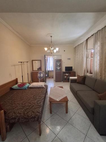 a living room with a couch and a living room at Kaloxori Apartment - Limnothalassa in Thessaloniki