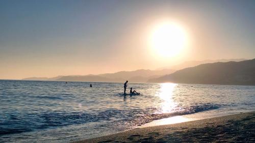 a person standing in the water at the beach at Paraíso del Sol in Salobreña