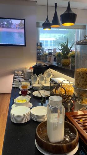 a buffet line with white plates and other food at Microtel by Wyndham Acropolis in Manila