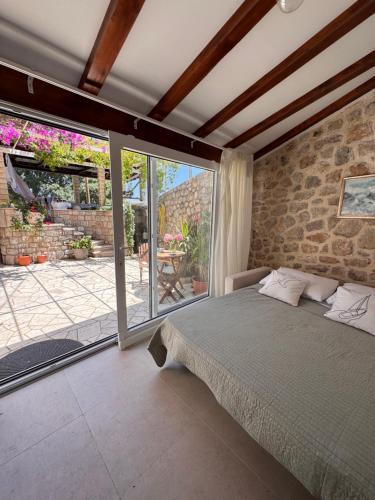 a bedroom with a bed and a large window at Apartment STONE by City Walls in Dubrovnik