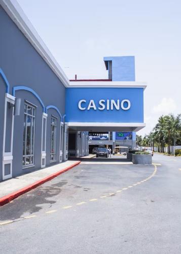 a gas station with a sign that reads casino at New ! Beachfront Villa - Golf, Pool & Ocean View in Dorado