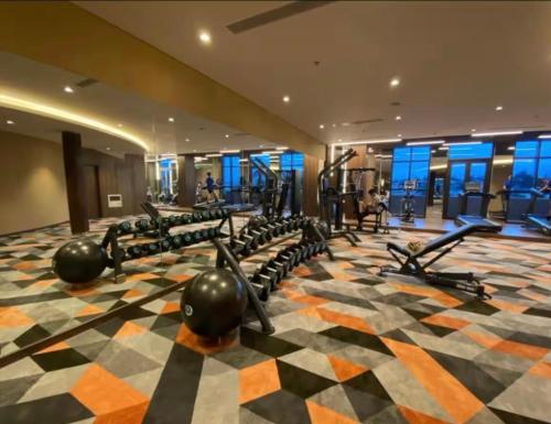 a gym with a lot of treadmills and machines at Mandala Muine M2012A in Phan Thiet