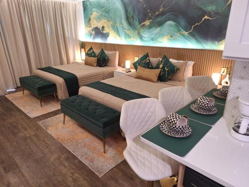 a hotel room with two beds and a table and chairs at Emerald Luxe Lakeview 6 min to EPIC Universe in Orlando