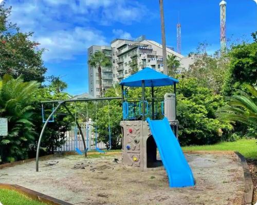 a playground in a park with a blue slide at Emerald Luxe Lakeview 6 min to EPIC Universe in Orlando