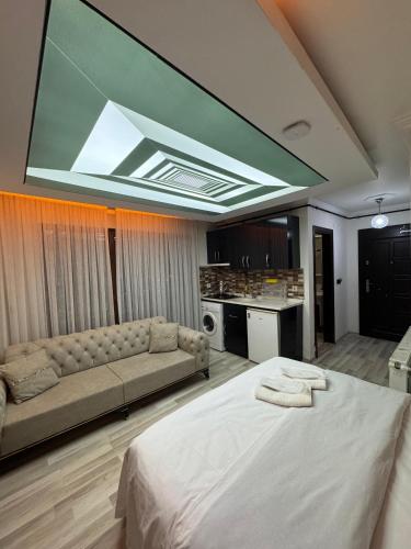 a living room with a large bed and a couch at Uluhan Suite Otel in Bostancı