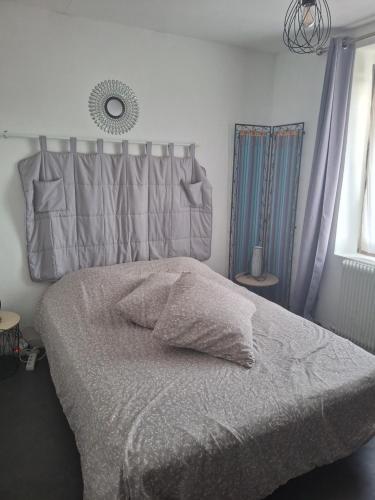 a bedroom with a bed and a mirror on the wall at Chambre in Plérin