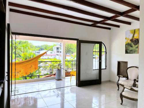 a living room with a door open to a balcony at Doral House Villavicencio in Villavicencio