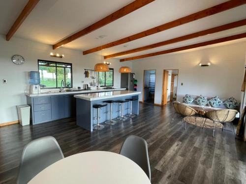 a large kitchen with a table and a couch at Tama House in Hanga Roa