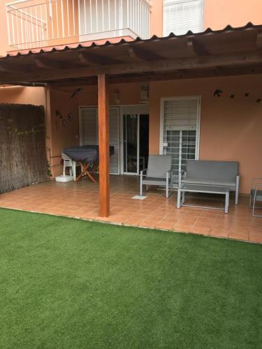 a patio with a table and a bench on it at ISLANTILLA - URB GREEN 7 in Islantilla