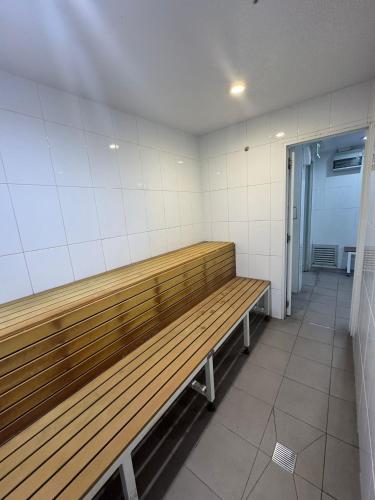 a wooden bench in a room with a hallway at Royal Palm Resort on the Beach in Gold Coast
