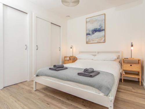 a bedroom with a white bed with two towels on it at Faodail in Portree